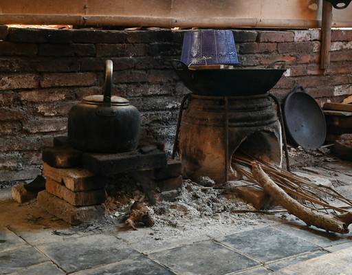 A certified stove installer or chimney sweep on the job, with safety equipment