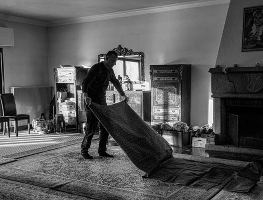 A professional chimney sweep inspecting and cleaning a stove chimney