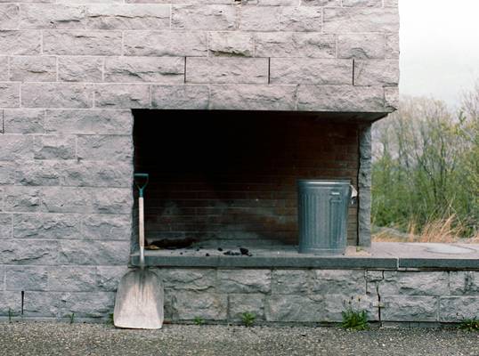 A professional installing a coal stove and inspecting chimney for safety