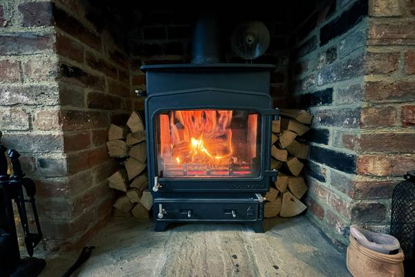 A modern, eco-friendly wood or pellet stove in a bright, sustainable home environment