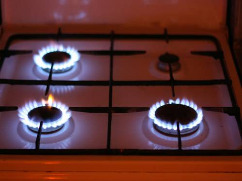 A close-up of an electric stove with visible controls and flame effect