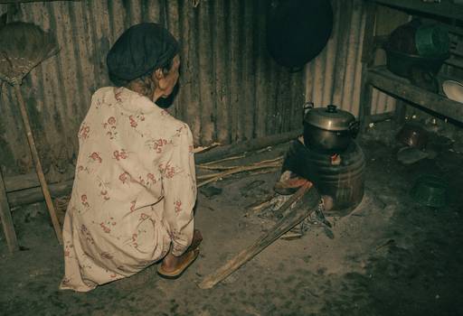 A person plugging in and positioning an electric stove in a safe spot