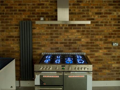 A new non-combustible hearth pad and marked wall clearances for a stove installation
