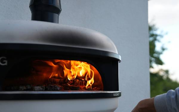 A modern, high-efficiency heating stove operating in a cozy, eco-friendly home