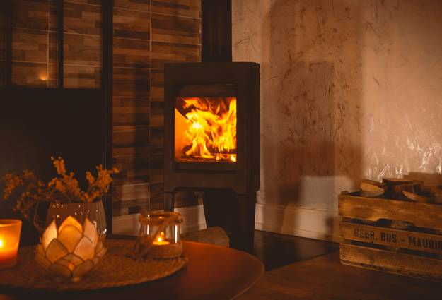 A modern gas stove operating in a stylish, comfortable living room