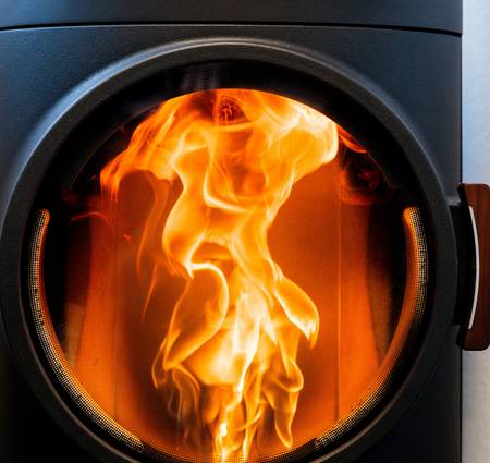 A knowledgeable expert reviewing heating stove options for a homeowner