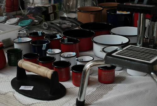 A collection of stove cleaning tools: ash vacuum, brush, gloves, metal bucket