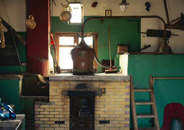 A professional installing stove venting and inspecting a chimney in a modern home